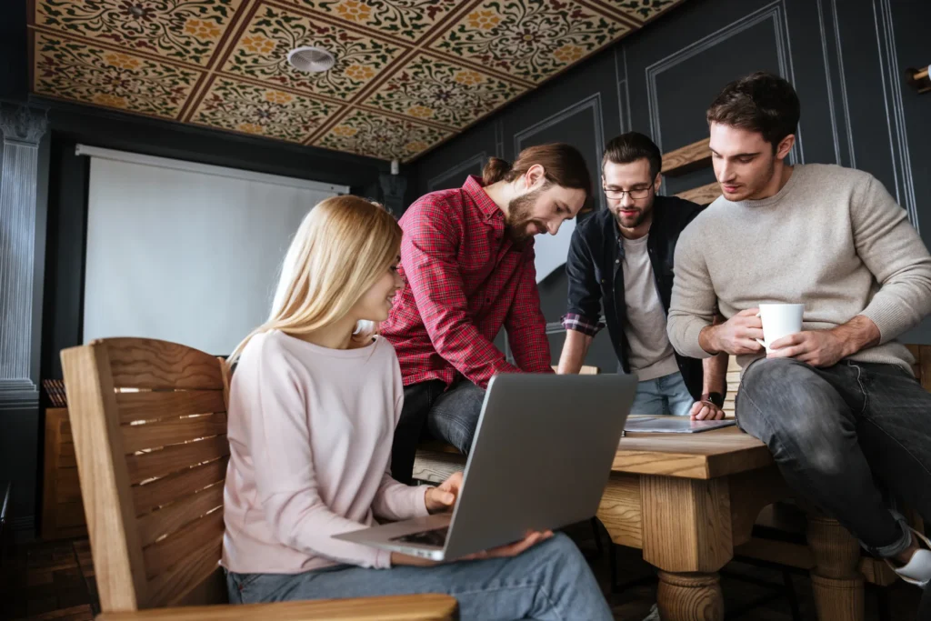 attractive-colleagues-standing-office-coworking